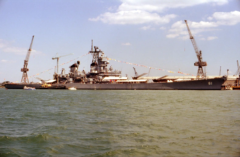 two large ships sit at the dock in the harbor