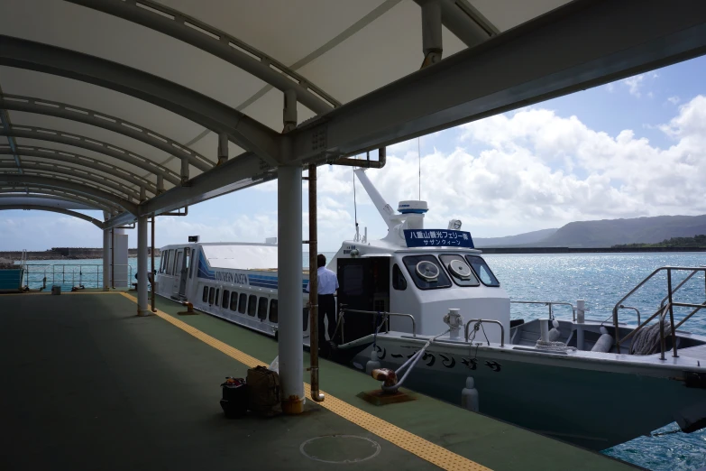 a ferry boat sitting at the dock with passengers