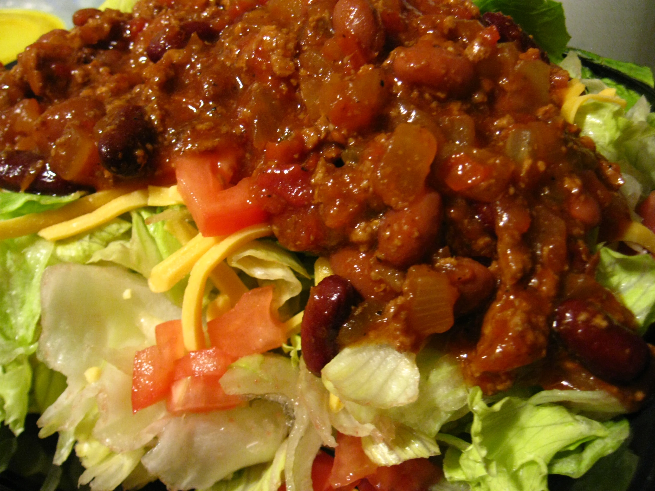 a meal with lettuce, carrots, tomatoes and sauce