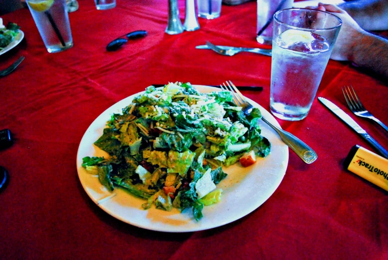 a plate of food is next to two glasses