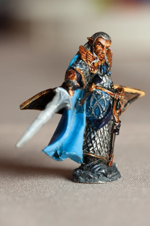 a miniature figurine is posed as a medieval warrior