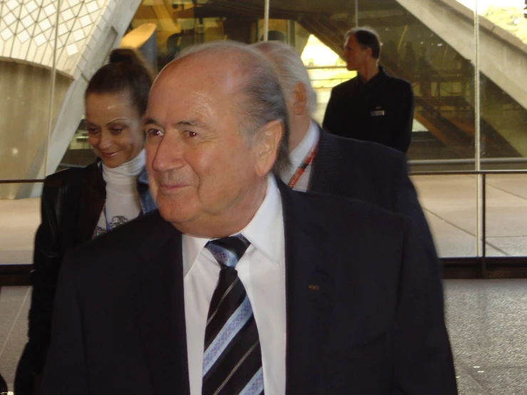 a smiling older man is shown in an airport