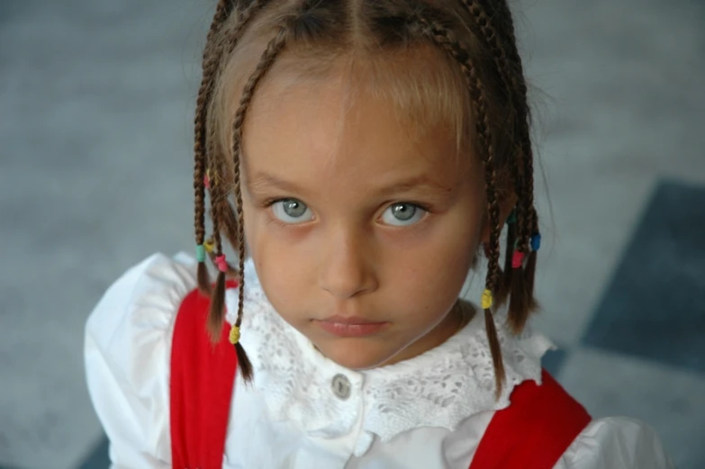 a girl with blue eyes looks into the camera