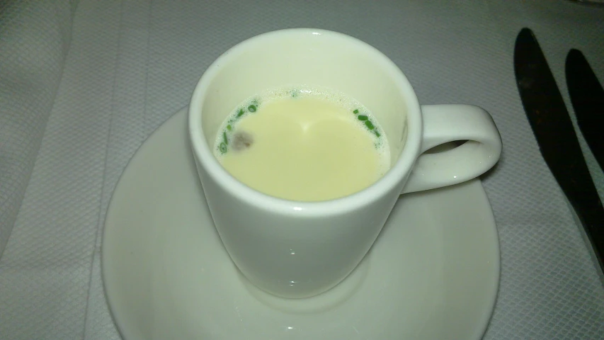 the dish features a cup filled with liquid