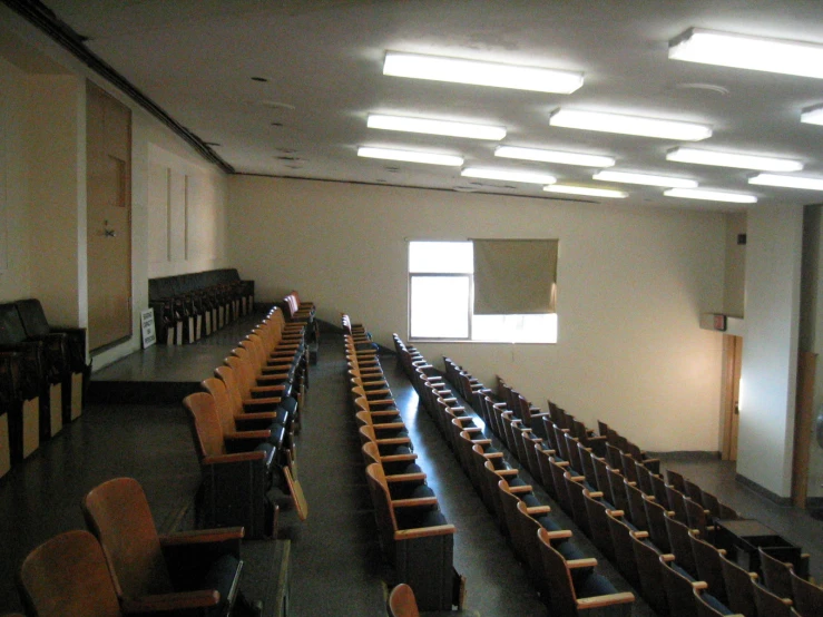 empty auditorium seating and window is lit on a very sunny day