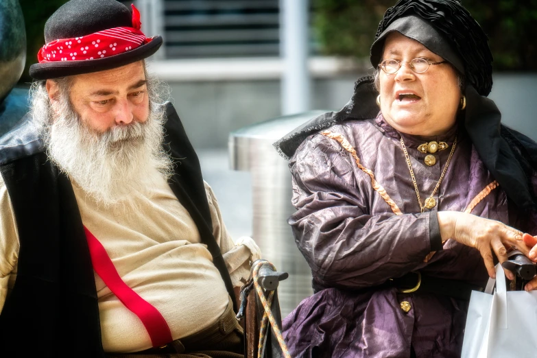 old people sitting down and talking outside of a building