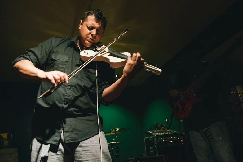 a man holding a violin in his right hand