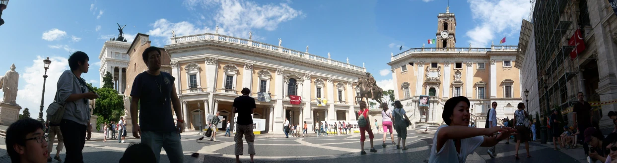 there are people standing in the square next to some buildings