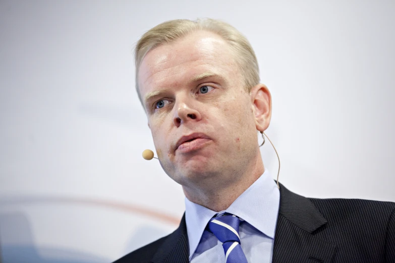 a close up of a person in a suit and tie