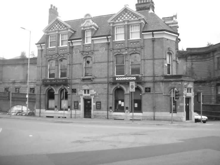 an old building with tall steeple and stone arches on the roof