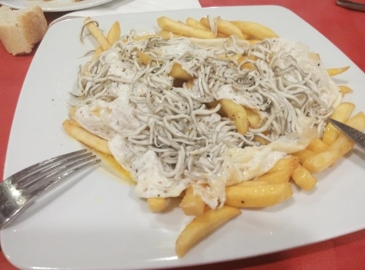 a plate filled with pasta and a knife