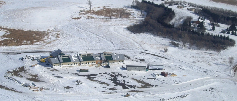 an aerial s of a big house on a snowy hill