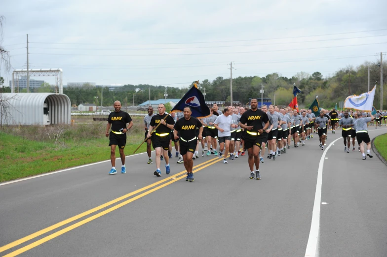 a marathon in the middle of the road with a man on one side