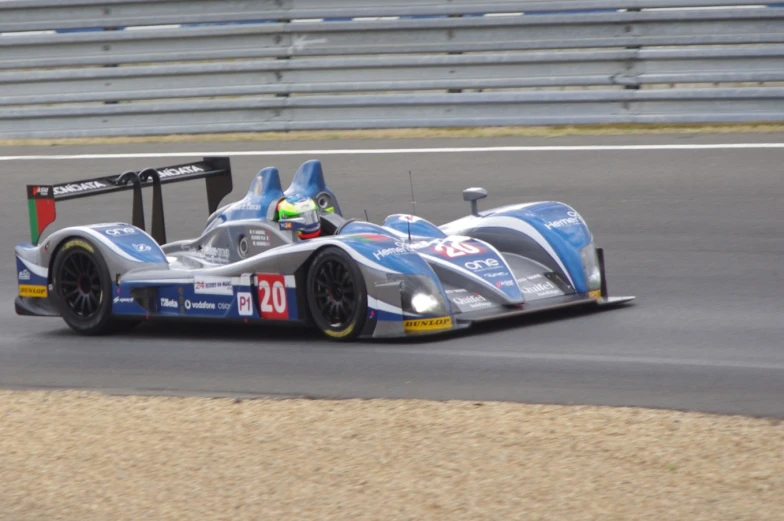 a race car racing on a track with numbers on it