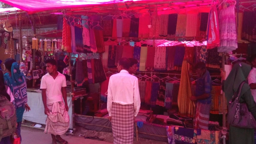 three women are looking through sarom shop window