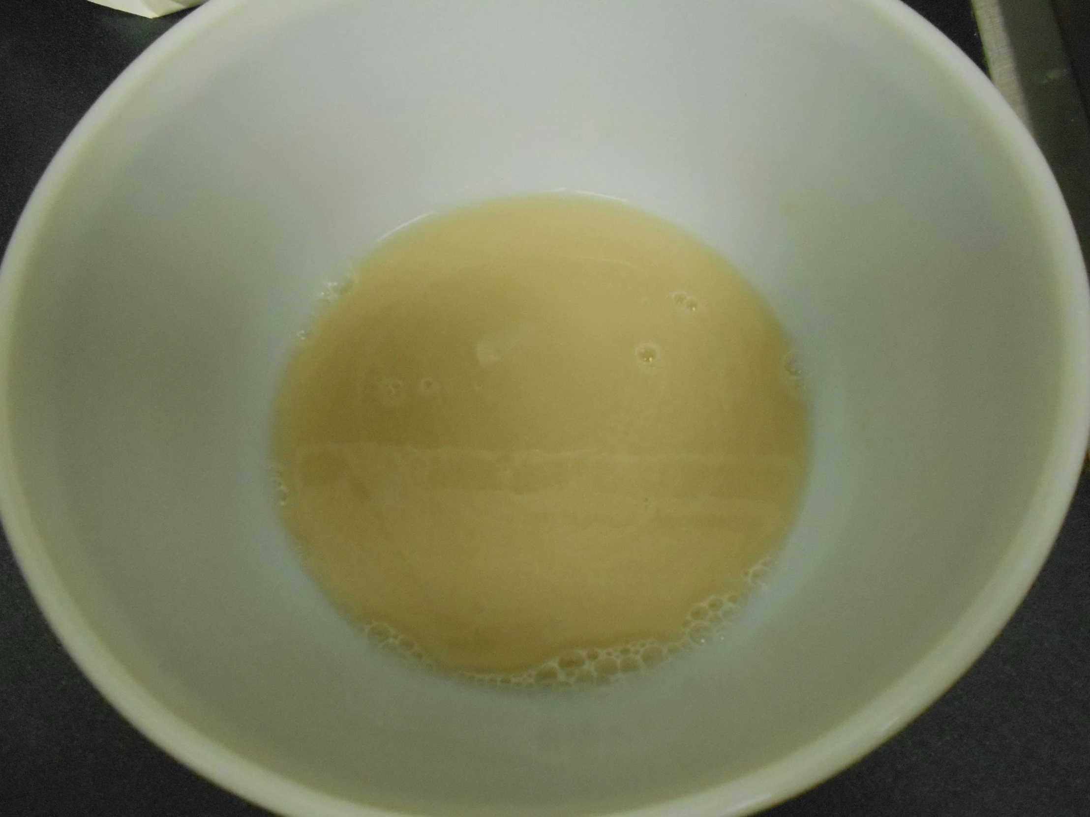 a bowl of milk sits on top of a table