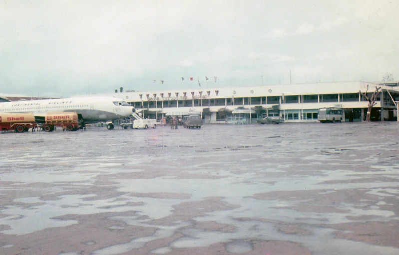 two airplane parked outside of an airport hangar