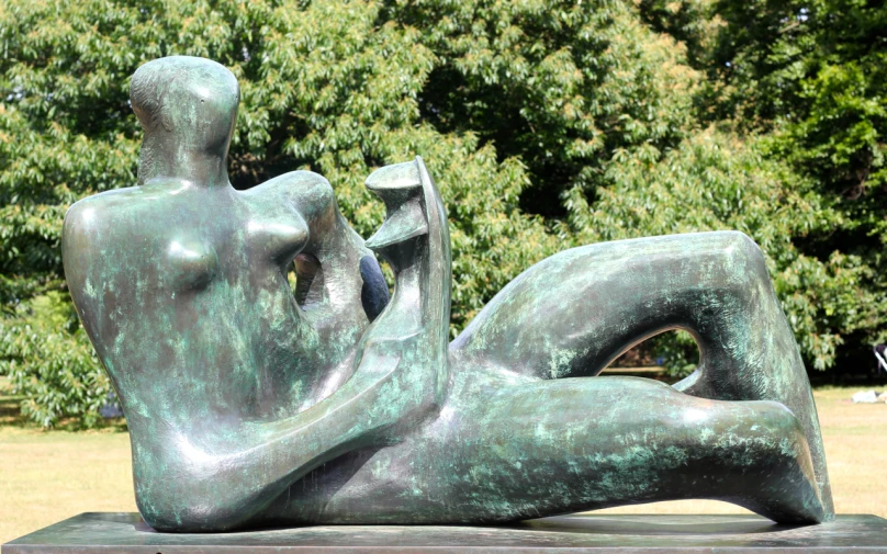 a statue of a woman sitting with a man with his arm behind her