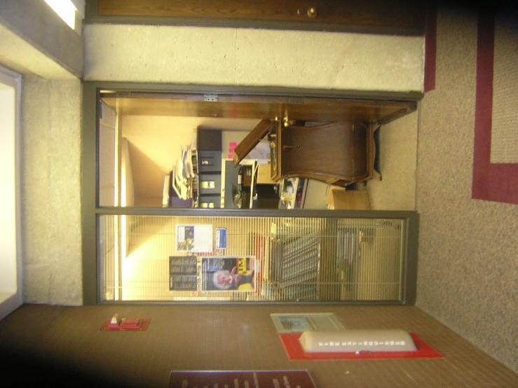 a room with many books on the shelf and one book in the open window