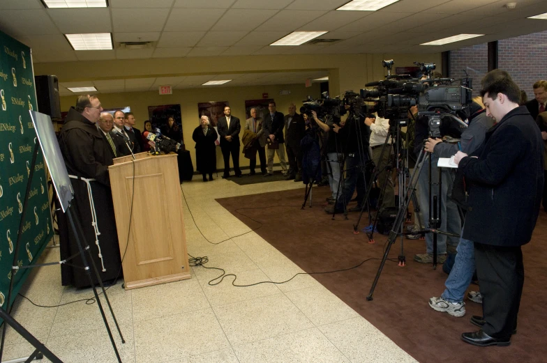 a group of people in a room with cameras and speakers