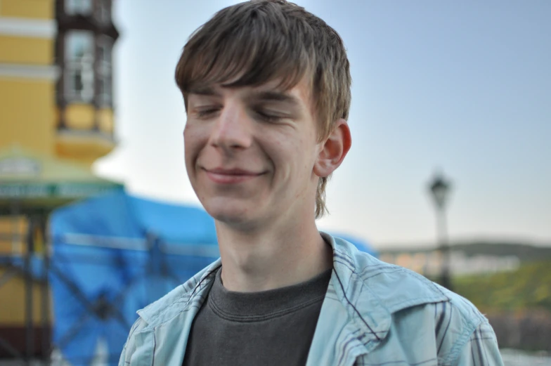 a man standing outside and smiling at soing