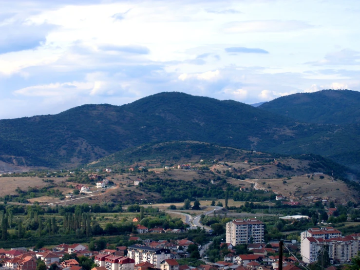 a village nestled on the hillside in a mountain range