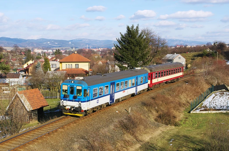 a train traveling down tracks next to a house