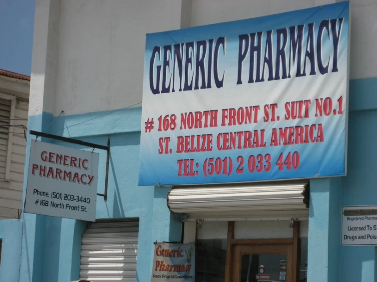 a pharmacy building with some signs hanging from it's windows