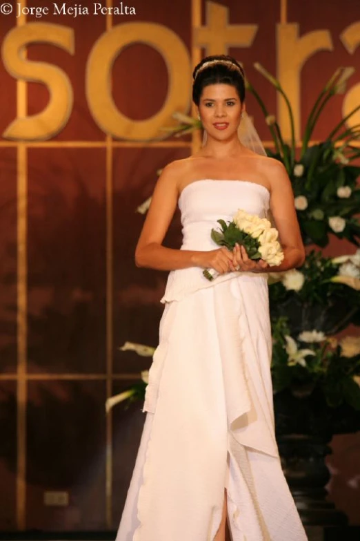 a woman on the runway of a fashion show wearing white dresses