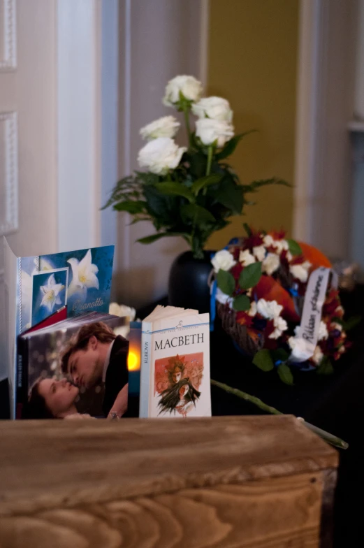 a flower and candles are in a wood case