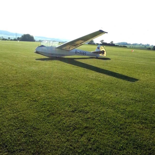 a small airplane is parked on a grassy field