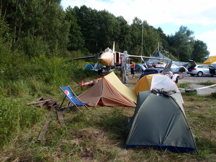 tents, tents and airplane at an airshow in the park