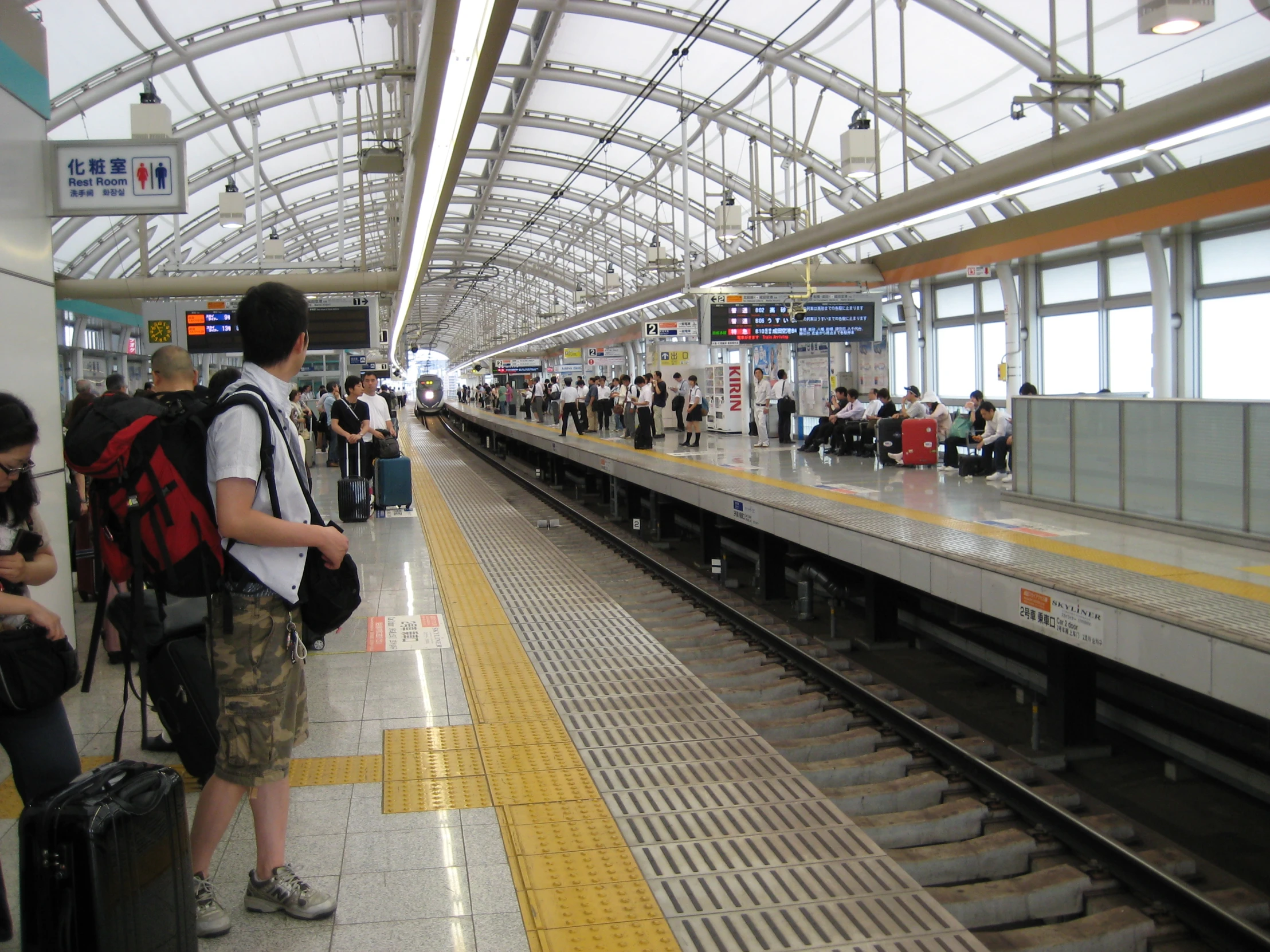 the people are waiting on the train platform to get on