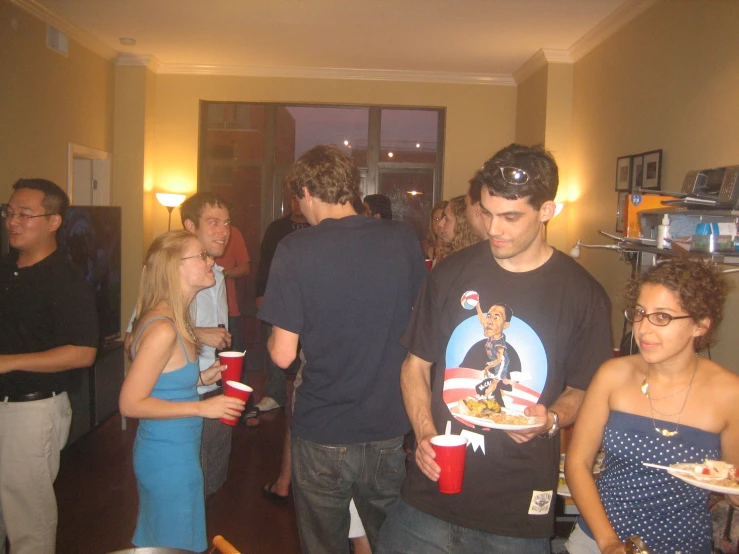 many people are standing together having drinks