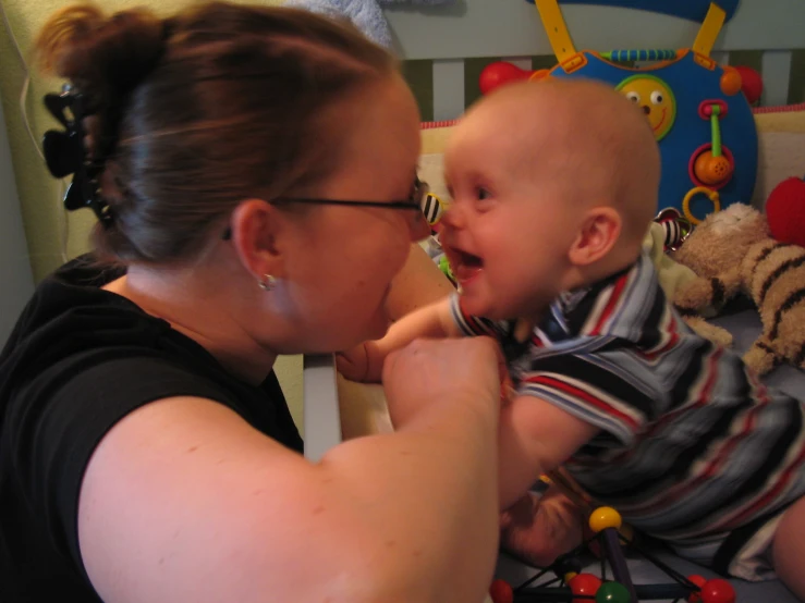 a woman holds a baby in her lap