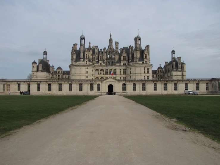 large castle with two flags on it and lots of windows