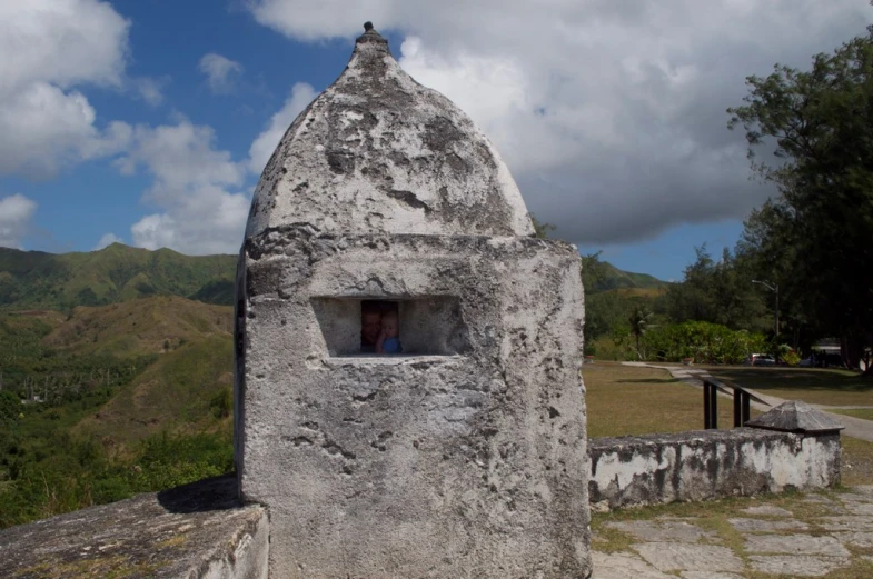 a gray cement structure with a window in it