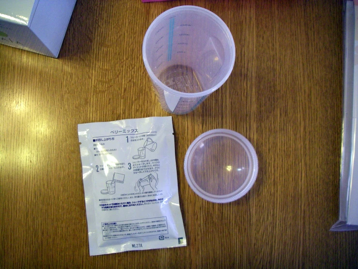 three empty containers on top of a wooden table