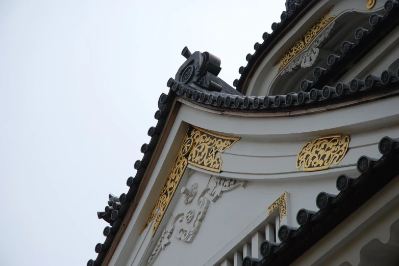 the building is decorated with gold details in its roof