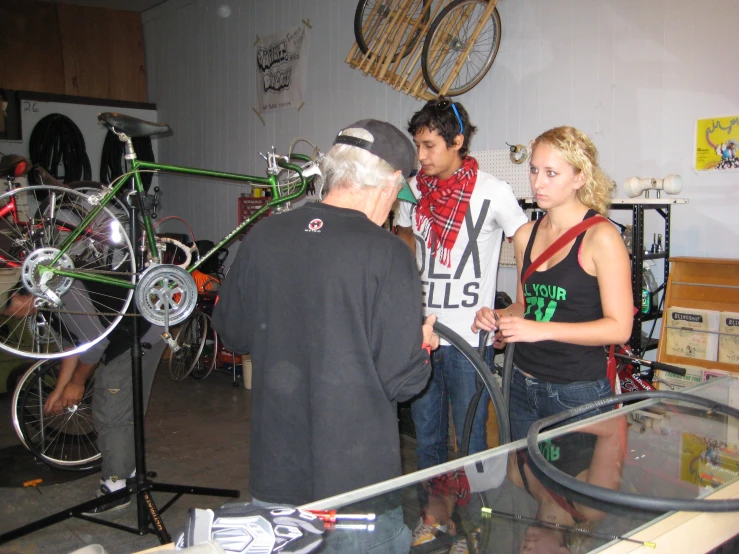a man and woman standing in front of a bike shop
