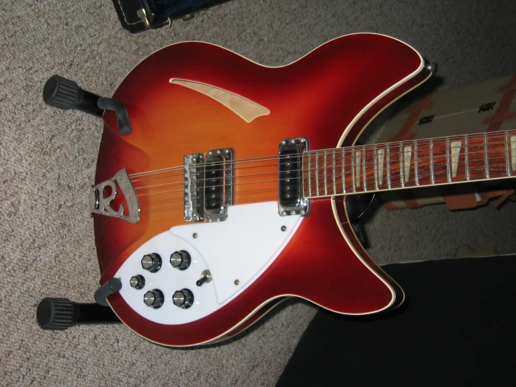 an electric guitar sitting on top of a carpet