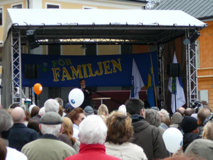 crowd of people and speakers at outdoor event