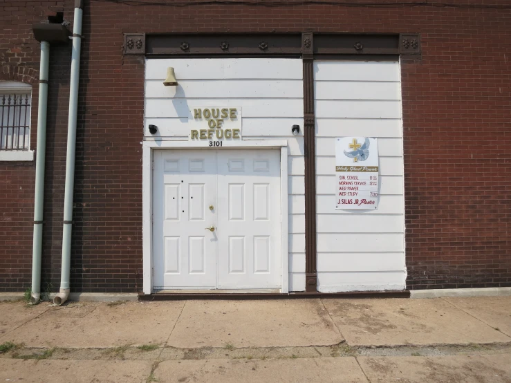 two white doord areas next to each other in front of a building