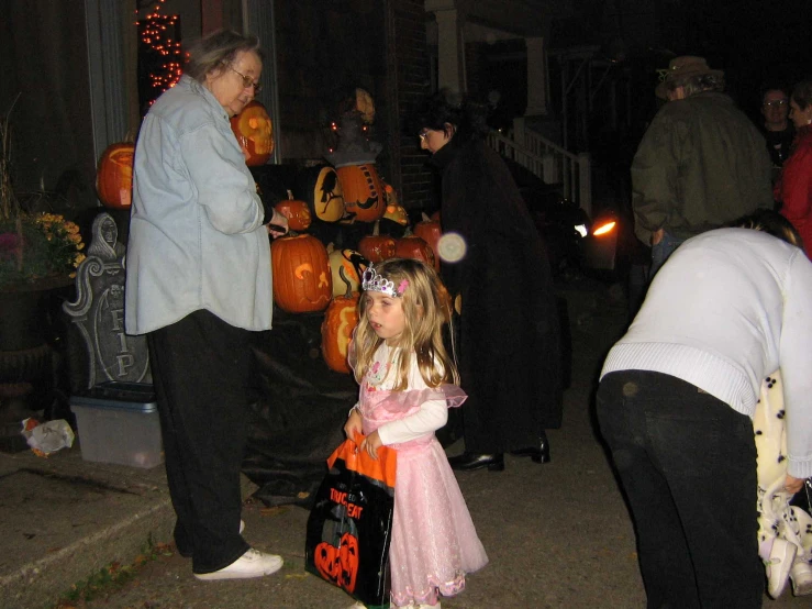 a little girl wearing a halloween costume