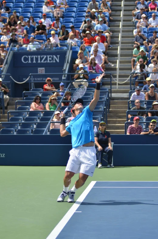 a man playing tennis about to serve a ball