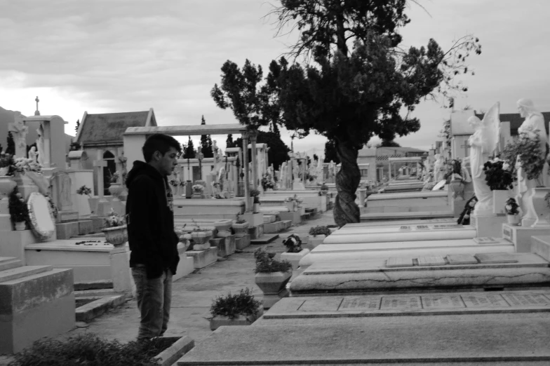 a person standing on top of some steps near a graveyard