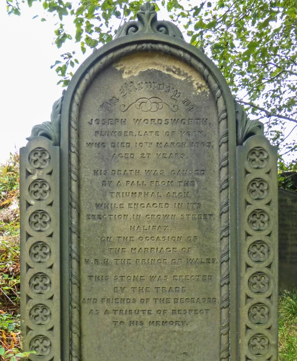 a close up of a stone grave with writing