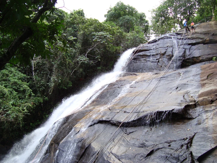 there is a very tall waterfall next to a road