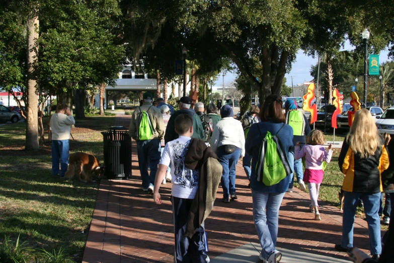 a group of people walk through a park