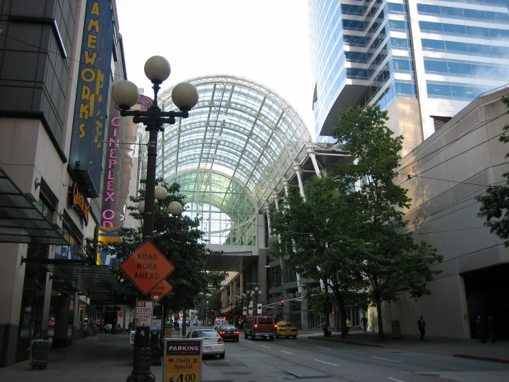 an almost empty street with lots of buildings and cars